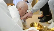 Pope Francis kisses the foot of one of the 12 women whose feet he washed at the Rebibbia Women’s Prison in Rome on Holy Thursday, March 28, 2024.