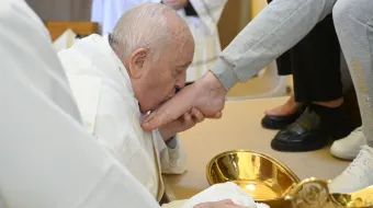 Pope Francis kisses the foot of one of the 12 women whose feet he washed at the Rebibbia Women’s Prison in Rome on Holy Thursday, March 28, 2024.