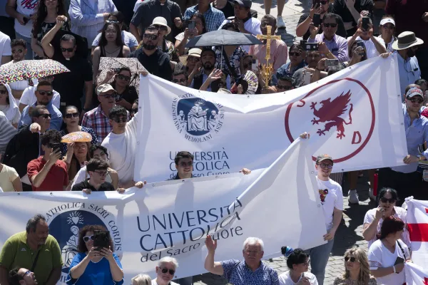 Pilgrims gathered in St. Peter’s Square at the Vatican hold banners during the recitation of the Regina Caeli prayer and address by Pope Francis on April 14, 2024. Credit: Vatican Media