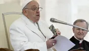 Pope Francis holds a rosary and New Testament that belonged to a slain 23-year-old Ukrainian soldier as he appeals for peace during his general audience on Wednesday, April 3, 2024.