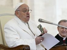 Pope Francis holds a rosary and New Testament that belonged to a slain 23-year-old Ukrainian soldier as he appeals for peace during his general audience on Wednesday, April 3, 2024.