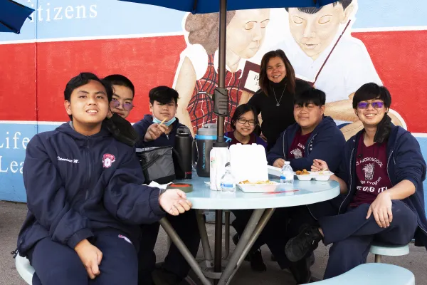 Eighth-graders at the lunch table with Precious Blood School principal Maria Cunanan in Los Angeles. Credit: Victor Alemán/Angelus News