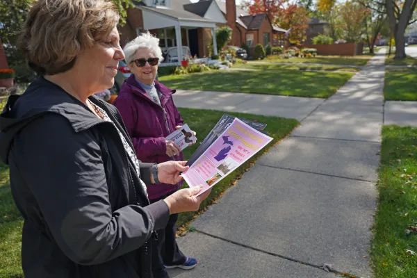 Paula Dixon, left, and Peggy Stack of the National Shrine of the Little Flower Basilica in Royal Oak, Michigan, canvass a neighborhood in opposition to Proposal 3 on Oct. 14. Canvassers are encouraged to visit supportmiwomenandchildren.org to sign up to canvass, give to the "No on Proposal 3" campaign, and order yard signs. Dan Meloy | Detroit Catholic