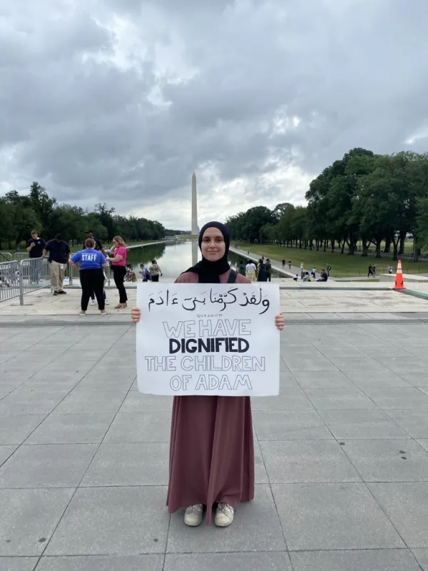 Sameerah Munshi, a recent graduate of Brown University who is interning with the Religious Freedom Institute, holds a sign with a verse from the Quran about the sanctity of life that reads “We have dignified the children of Adam" at a pro-life rally at the Lincoln Memorial on June 24, 2023. Lauretta Brown/CNA