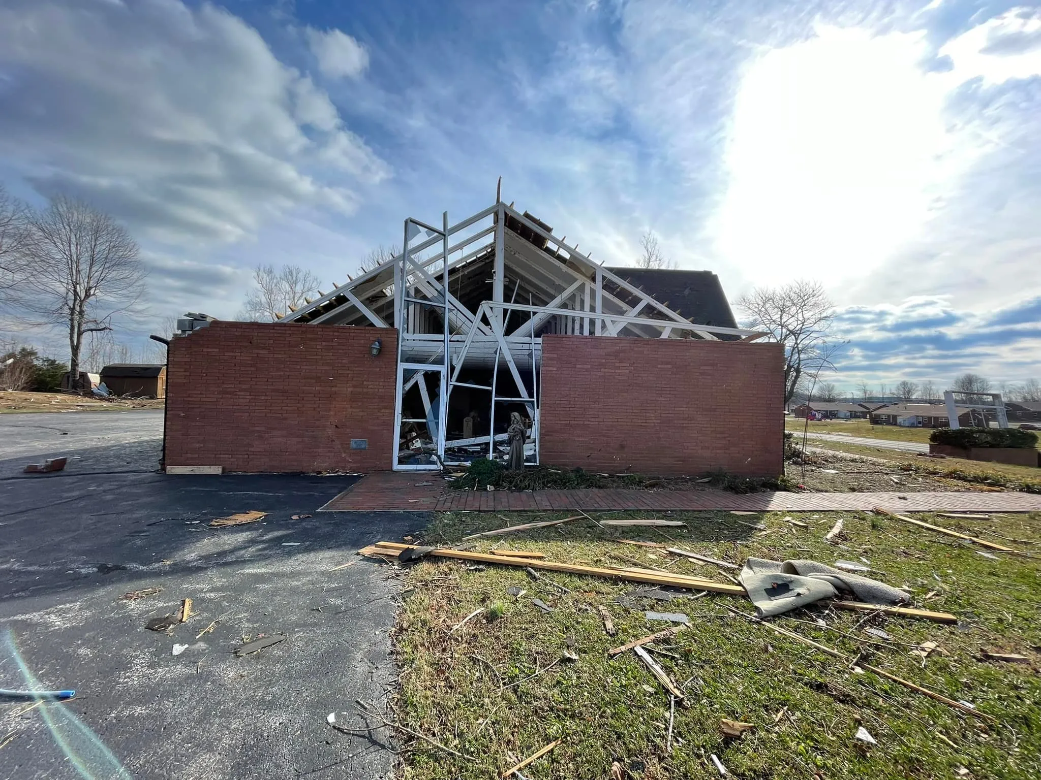 A Marian statue stands before Resurrection Catholic Church in Dawson Springs, Ky., after the church was heavily damaged by a tornado Nov. 11, 2021.?w=200&h=150
