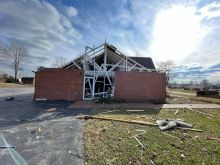 A Marian statue stands before Resurrection Catholic Church in Dawson Springs, Ky., after the church was heavily damaged by a tornado Nov. 11, 2021.