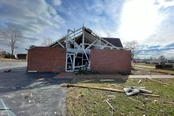 A Marian statue stands before Resurrection Catholic Church in Dawson Springs, Ky., after the church was heavily damaged by a tornado Nov. 11, 2021.