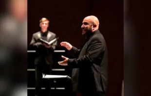 Richard Carrillo, director of “Requiem for the Forgotten,” conducts a choir. Carrillo is finishing his doctorate in choral conducting at the Frost School of Music at the University of Miami. Credit: Kevin White