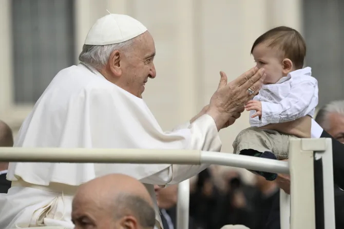 Pope Francis blesses a baby in St. Peter's Square on March 8, 2023.