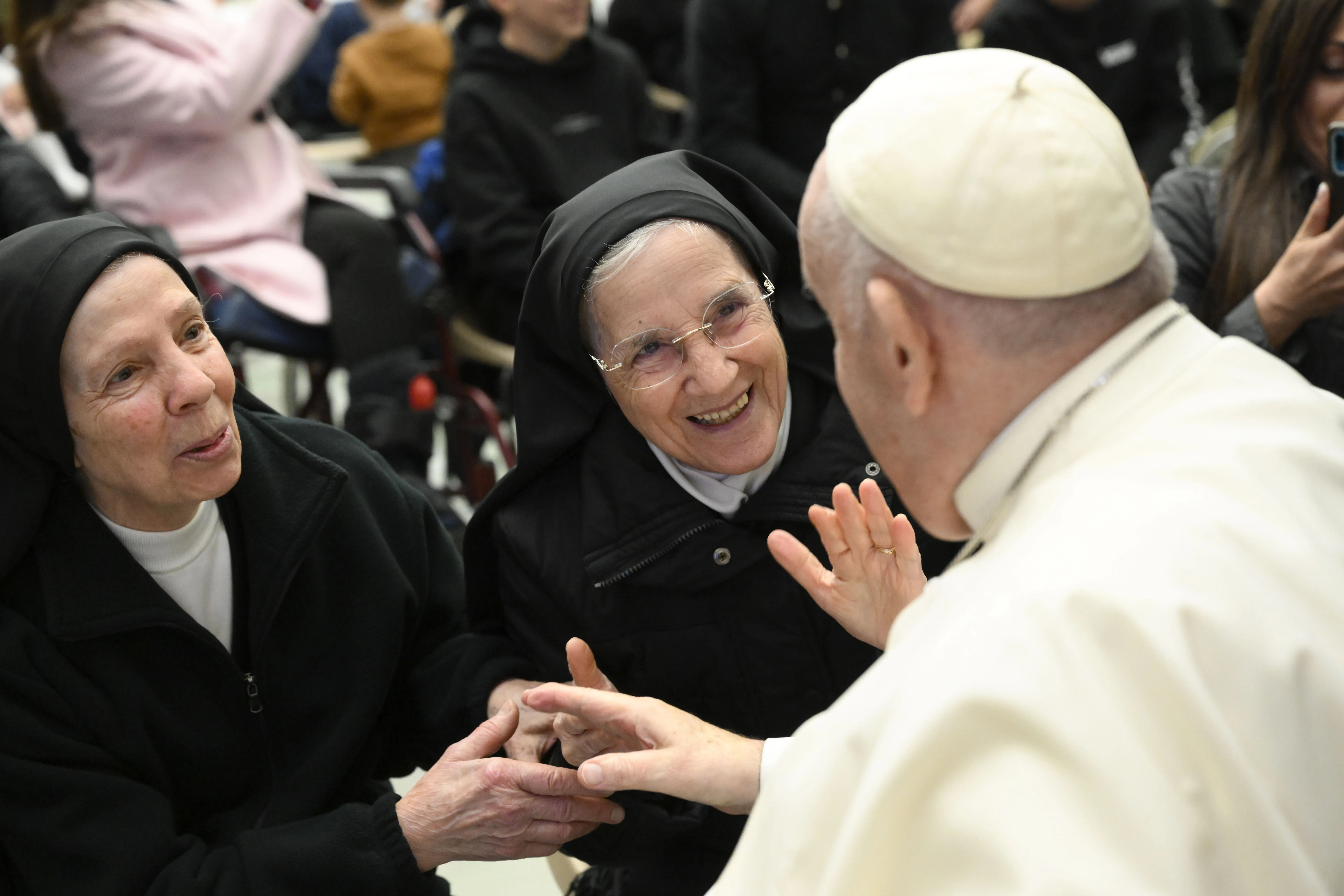 Pope Francis smiles with two religious sisters during his general audience on Jan. 11, 2023?w=200&h=150