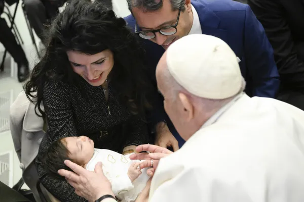 Pope Francis speaks to a family during his general audience on Jan. 11, 2023. Vatican Media