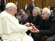 Pope Francis greets an elderly couple at his general audience on Jan. 11, 2023.
