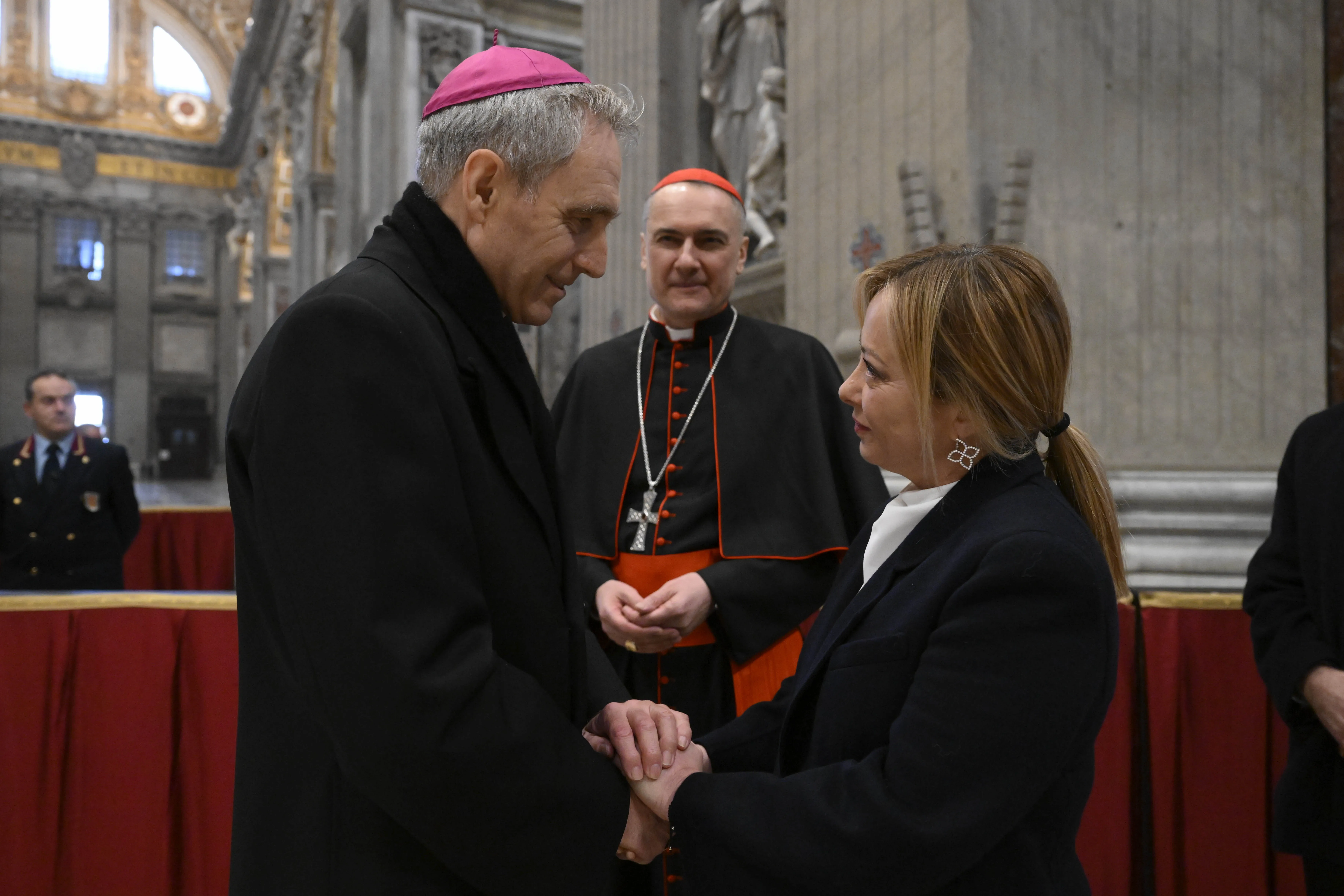 Archbishop Georg Gänswein, the longtime personal secretary of Benedict XVI, greets Italy's Prime Minister, Giorgia Meloni, on Jan. 2, 2023, at St. Peter's Basilica, where Benedict is lying in state.?w=200&h=150