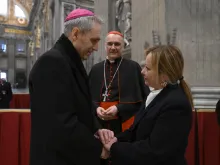 Archbishop Georg Gänswein, the longtime personal secretary of Benedict XVI, greets Italy's Prime Minister, Giorgia Meloni, on Jan. 2, 2023, at St. Peter's Basilica, where Benedict is lying in state.