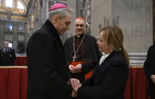 Archbishop Georg Gänswein, the longtime personal secretary of Benedict XVI, greets Italy's Prime Minister, Giorgia Meloni, on Jan. 2, 2023, at St. Peter's Basilica, where Benedict is lying in state. Vatican Media