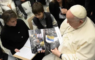 Pope Francis looking at images from Ukraine at the general audience, Dec. 21, 2022 Vatican Media
