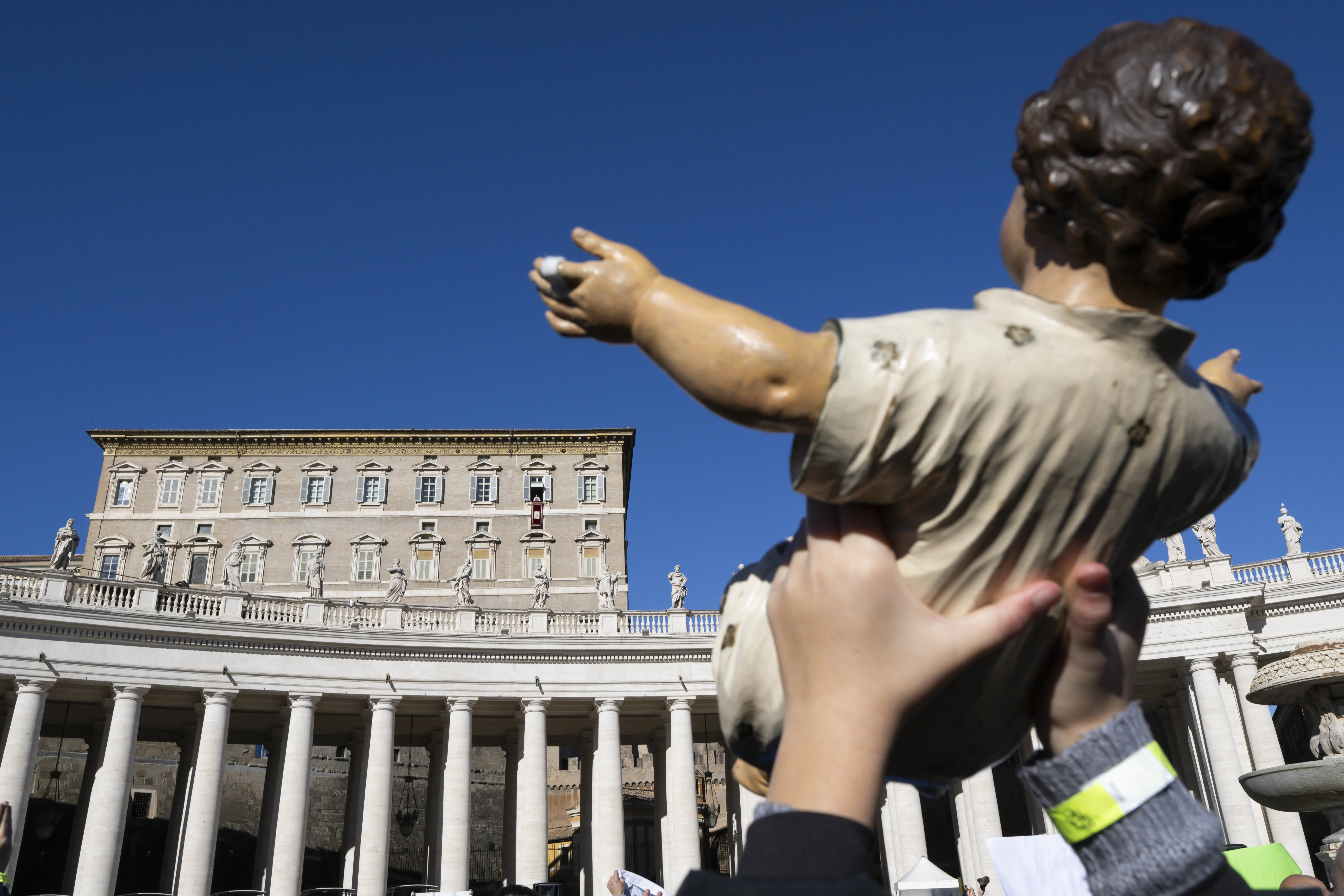 A member of the crowd in St. Peter's Square holds up a baby Jesus figure for a blessing by Pope Francis at his Sunday Angelus Dec. 17, 2023.?w=200&h=150