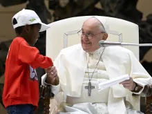 Pope Francis shakes hands with one of the approximately 7,000 children from around the world in the Vatican’s Paul VI Hall on Nov. 6, 2023, at an event sponsored by the Dicastery for Culture and Education dedicated to the theme “Let us learn from boys and girls.”