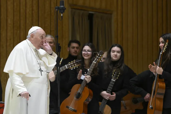 Pope Francis greets musicians from a youth orchestra who performed at the general audience on Feb. 15, 2023.