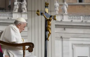 Pope Francis prays in front of a crucifix during his general audience on Oct. 26, 2022. Vatican Media