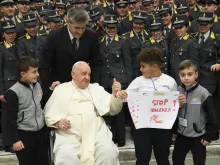 Pope Francis greets pilgrims and poses for photos at the end of his general audience on Nov. 29, 2023.