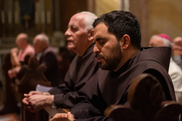 The parish priest of St. Saviour's Latin parish in Jerusalem and the assistant priest pray the rosary at a prayer service organized by the Franciscan friars of the Custody of the Holy Land on Saturday, Oct. 14, 2023. Credit: Marinella Bandini