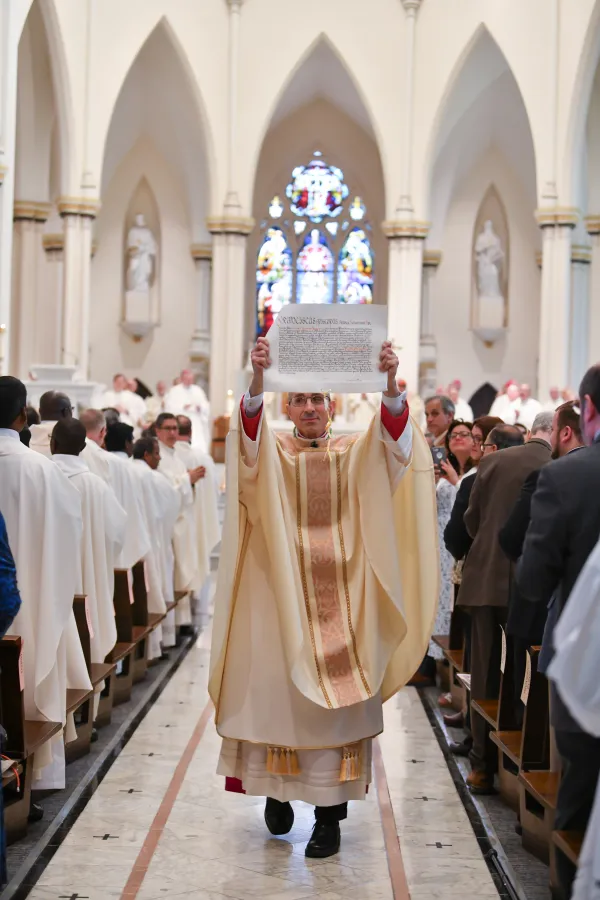 Bishop James Ruggieri displays his letter of appointment from the pope during his ordination Mass in Portland, Maine, on May 7, 2024. Credit: McKenney Photography