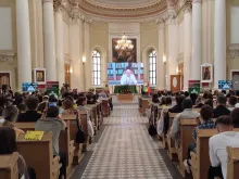 Young Catholics participating in the 10th edition of the Russian Youth Gathering in St. Petersburg, Russia, watch a livestream of Pope Francis at the Basilica of St. Catherine of Alexandria on Aug. 25, 2023.