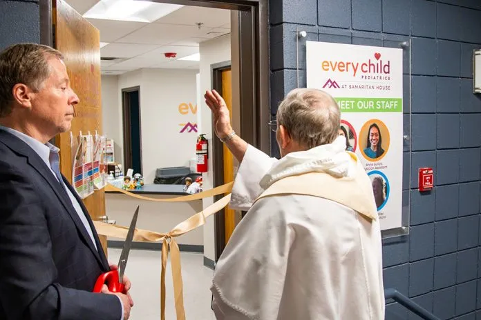 A priest blesses the new integrated pediatric clinic, one of the first of its kind to be based out of a shelter for families experiencing homelessness in the country, April 20, 2023, before the ceremonial ribbon cutting by Darren Walsh, president & CEO of Catholic Charities of Denver.?w=200&h=150