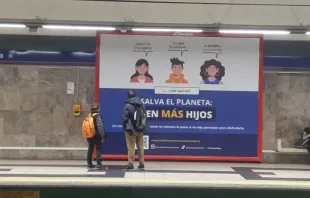 A father and son observe pro-natalist billboard campaign in Madrid, Spain. Credit: Large Families Association of Madrid