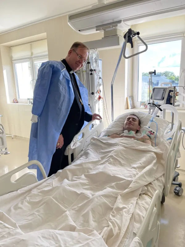 Archbishop Gintaras Grušas with an injured Ukrainian soldier. Photo courtesy of Father Andriy Zelensky