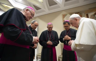 Pope Francis prays with French bishops before his general audience, Oct. 6, 2021, in the wake of a devastating abuse report. Vatican Media.