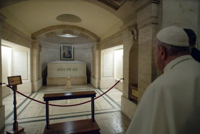 Pope Francis prays at the tomb of Pope Pius XII on Nov. 2, 2021