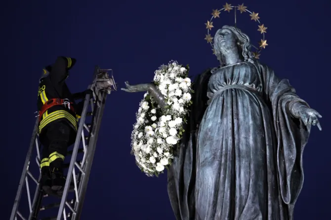 An Italian firefighter places a wreath of flowers on the statue of the Immaculate Conception in Rome’s Piazza di Spagna, Dec. 8, 2021