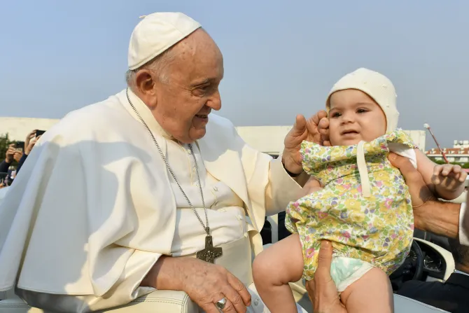 Pope Francis blesses a baby in Fatima, Portugal on Aug. 5, 2023.