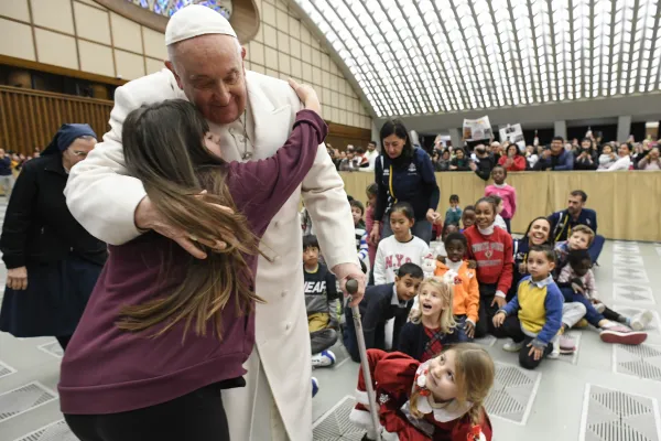 Pope Francis receives a hug on his birthday Dec. 17, 2023. The pope in the morning met with children and families who are assisted by the Vatican’s Santa Marta Pediatric Dispensary. Credit: Vatican News