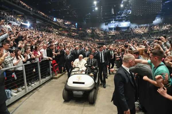 Pope Francis is driven on a cart inside a sports arena in Budapest, Hungary, on April 29, 2023, where he held a meeting with young people. Vatican Media
