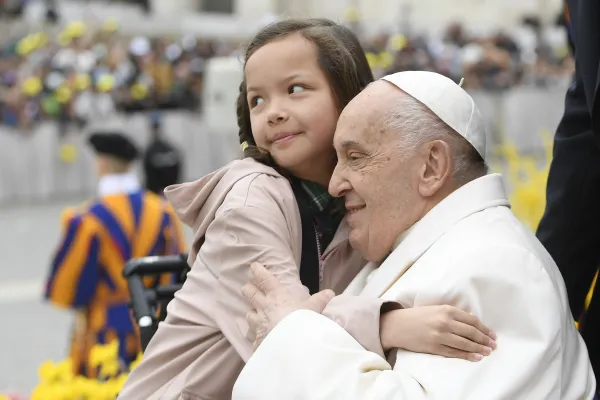 A young girl embraces Pope Francis during his general audience in St. Peter's Square on April 3, 2024. Credit: Vatican Media