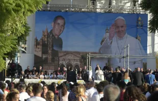 Pope Francis sits in front of an image of Blessed Giuseppe "Don Pino" Puglisi during a meeting with young people in the Archdiocese of Palermo, on the Italian island region Sicily, on Sept. 15, 2018. Vatican Media.