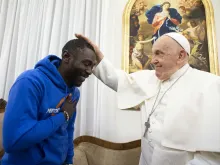 Pope Francis meets with 30-year-old Mbengue Nyimbilo Crepin, who shared his story during a meeting at the pope’s Vatican City residence Casa Santa Marta on Nov. 17, 2023.