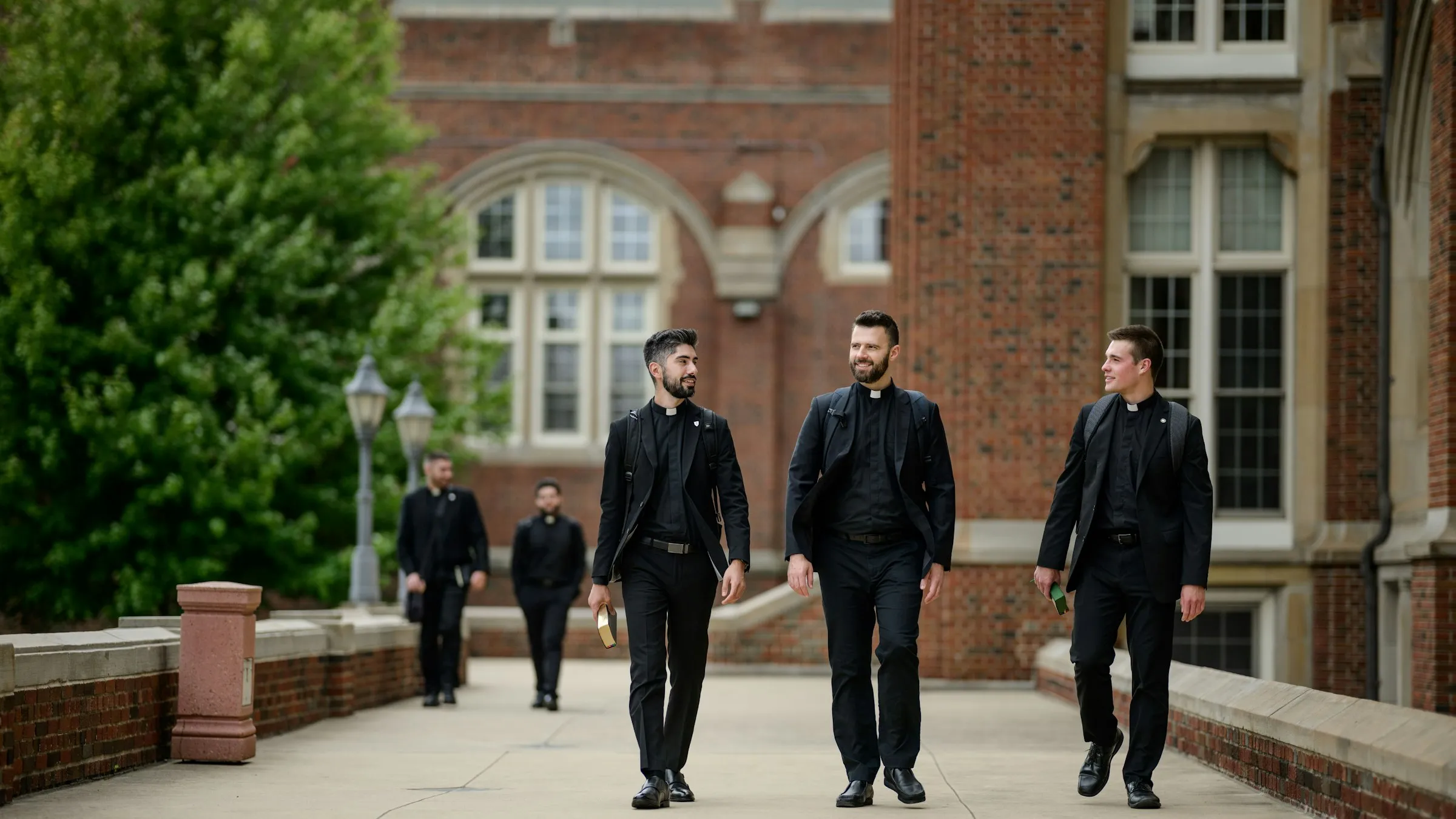 Seminarians chat as they walk along the promenade in front of Sacred Heart Major Seminary in Detroit. Starting in the fall semester of 2024, first-year seminarians at Sacred Heart and seminaries across the country will undertake a "propaedeutic" year focused on personal, spiritual, and relationship growth, limiting the use of technology while spending more time in prayer and communion with others.?w=200&h=150