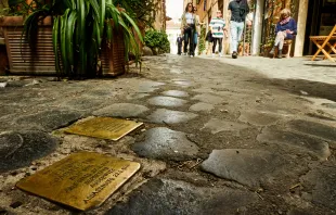"Stumbling blocks" in Rome, Italy. Plates inscribed with the name and dates of life of the victim of Nazi persecution. Shutterstock