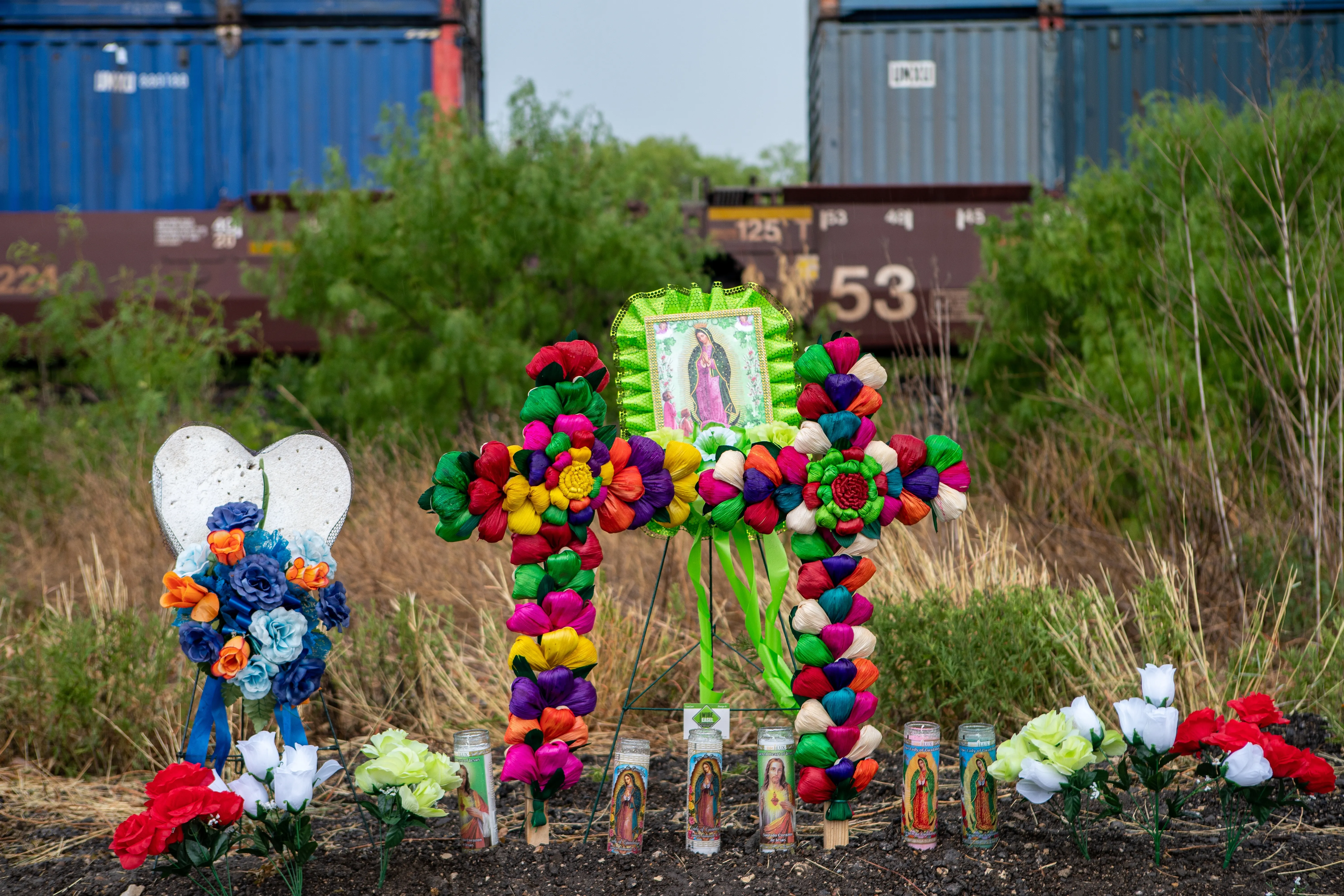 Texans brought prayer candles, bottles of water, and religious icons to a makeshift memorial at the site where 46 migrants were declared dead in San Antonio, Texas, in June 2022.?w=200&h=150