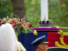 The Imperial State Crown, Sceptre, and wreath of symbolic flowers adorn the coffin of Her Late Majesty Queen Elizabeth II on the gun carriage for the funeral procession, Sept. 19, 2022.