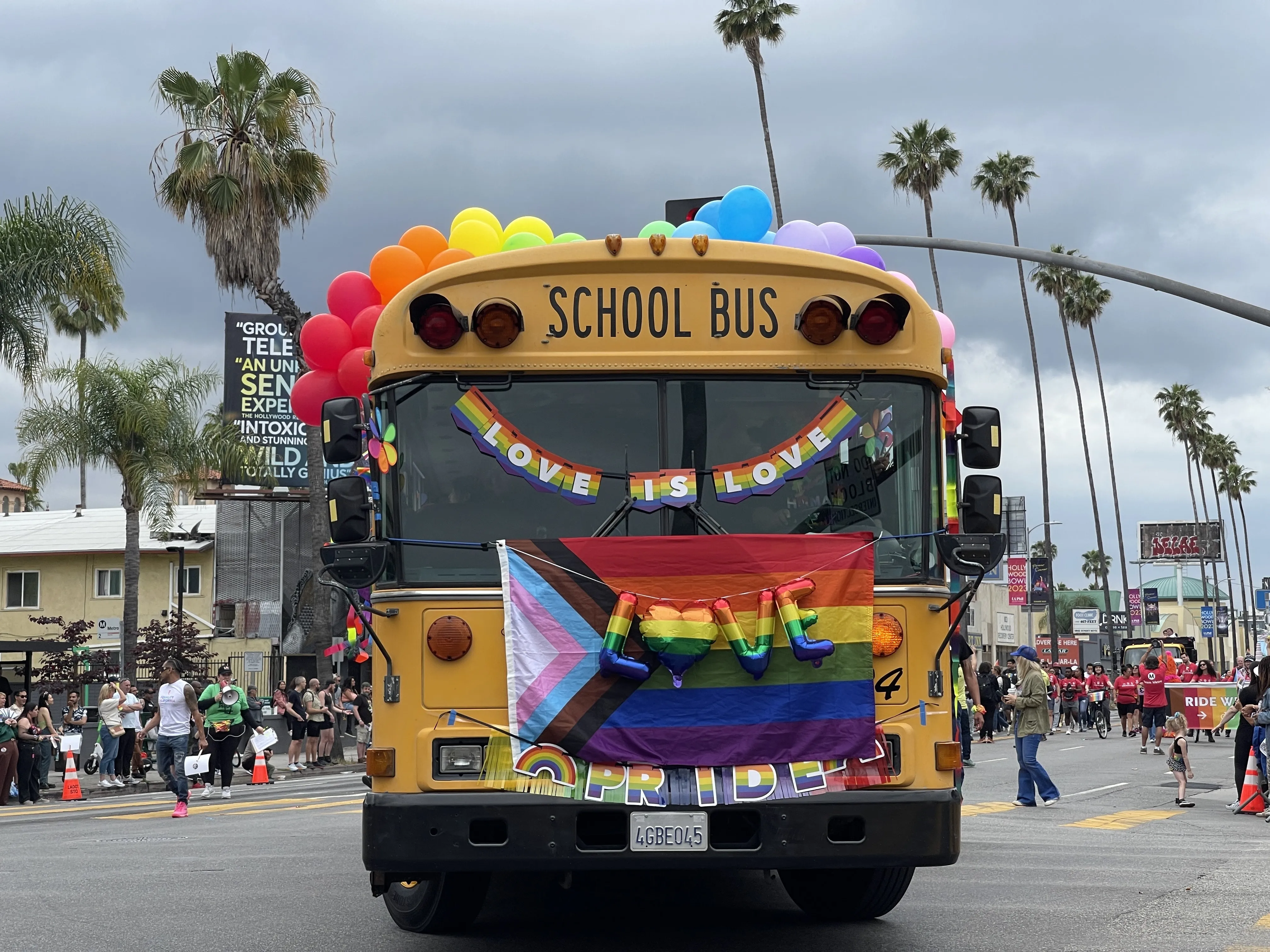 A school bus with rainbow-colored balloons, a Pride flag, and “love its love” signs drives in the Los Angeles Pride parade in Hollywood on June 11, 2023.?w=200&h=150