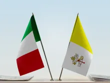 The flags of Italy and Vatican City.