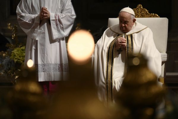 Pope Francis prays during Christmas Mass in St. Peter's Basilica on Dec. 24, 2023. Vatican Media