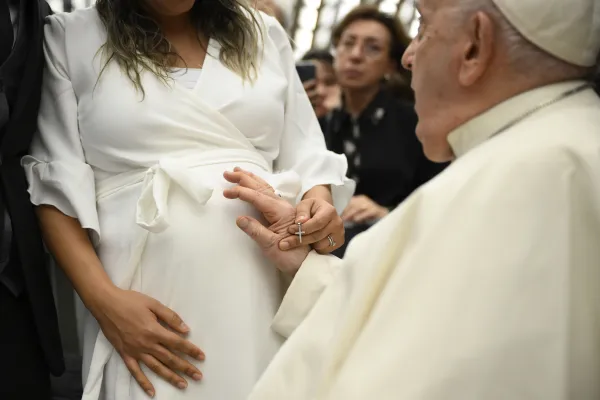 Pope Francis blesses a pregnant women during his Dec. 13, 2023, general audience in Paul VI Hall at the Vatican. Credit: Vatican Media