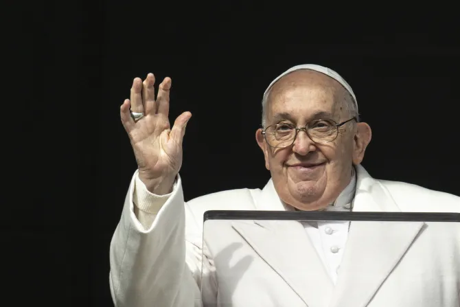 Pope Francis waves from the window of the Apostolic Palace as he gives his Angelus address on Friday, Dec. 8, 2023.