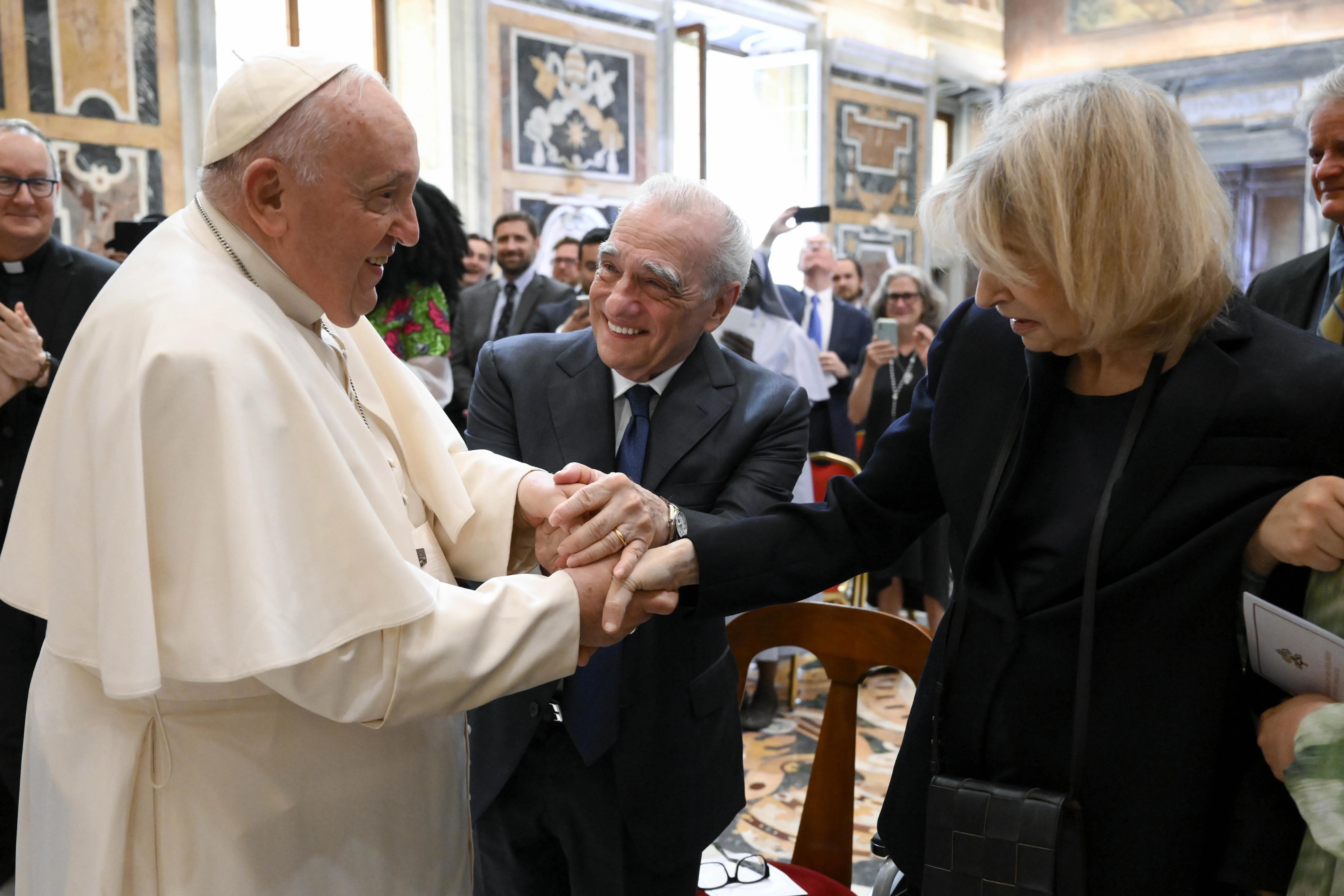 Pope Francis shakes hands with film director Martin Scorsese and his wife Helen Morris. One day after suffering from a fever, Pope Francis resumed his normal activities, including meeting with participants in a conference on “The Global Aesthetics of the Catholic Imagination,” organized by Jesuit magazine “La Civiltà Cattolica” and Georgetown University, in the Apostolic Palace on May 27, 2023.?w=200&h=150